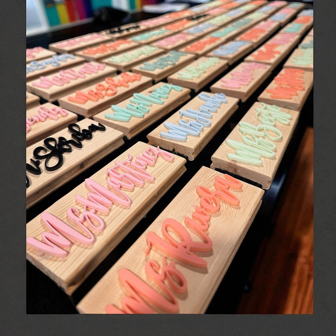 Set of wooden stamps with colorful lettering on a table. Customized By Madera1819